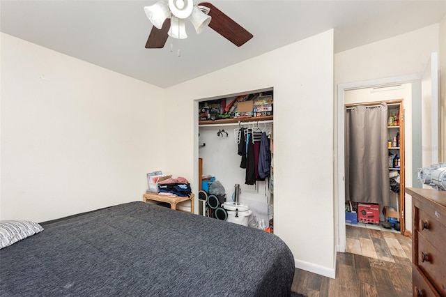 bedroom with ceiling fan, vaulted ceiling, dark wood-type flooring, and a closet