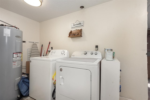 washroom featuring independent washer and dryer, a textured ceiling, and water heater