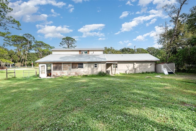 back of property featuring a lawn