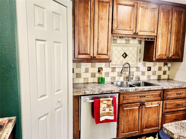 kitchen with decorative backsplash, dishwasher, light stone counters, and sink