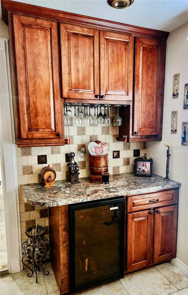 bar with decorative backsplash, light tile patterned floors, light stone countertops, and wine cooler