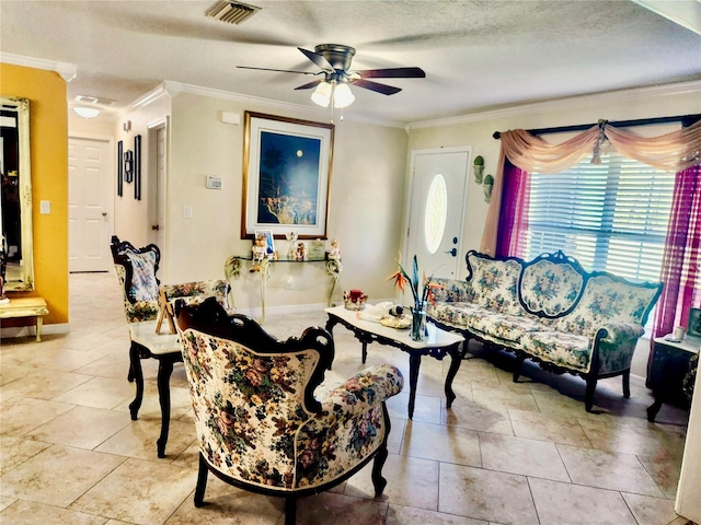 living room with ceiling fan, ornamental molding, and a textured ceiling