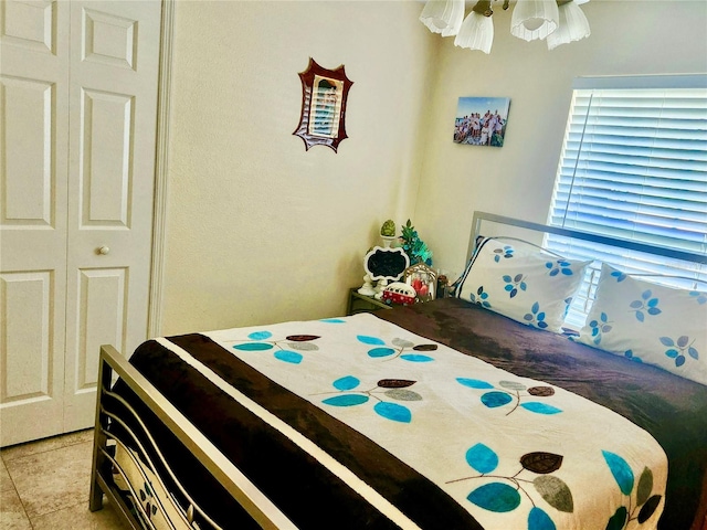 tiled bedroom featuring a closet