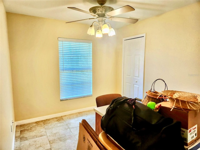 interior space with ceiling fan and a closet