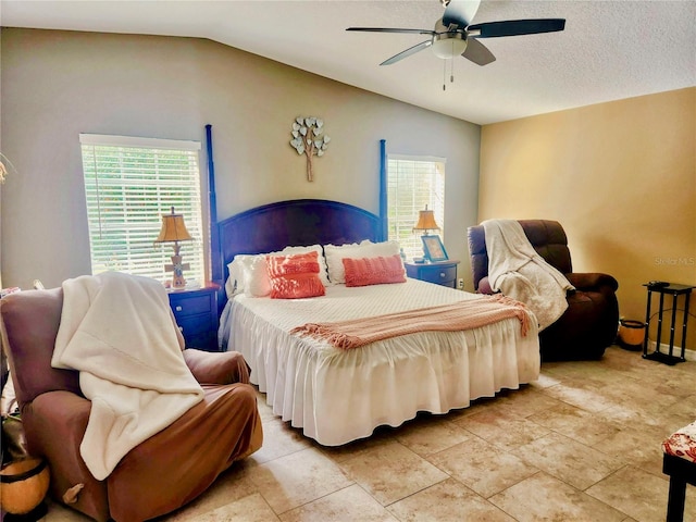 bedroom featuring ceiling fan, lofted ceiling, and multiple windows