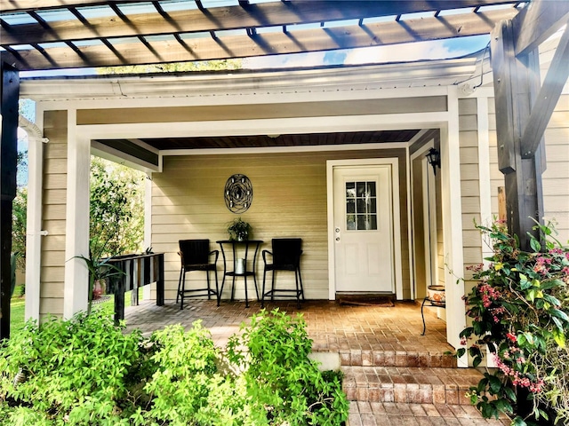 doorway to property with a pergola