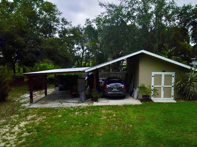 view of parking featuring a carport and a yard