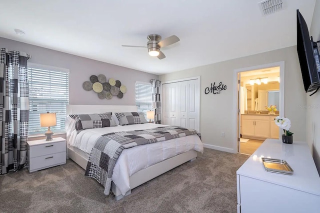 carpeted bedroom featuring ceiling fan, connected bathroom, and a closet