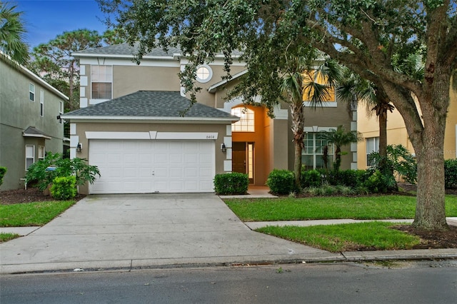 view of front of property featuring a garage and a front lawn