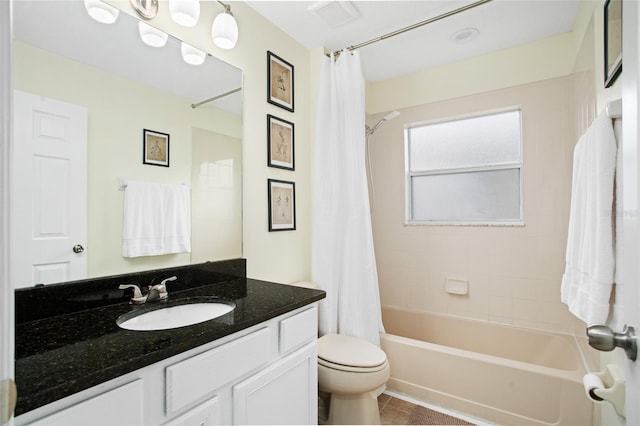 full bathroom with tile patterned flooring, shower / bath combo with shower curtain, vanity, and toilet