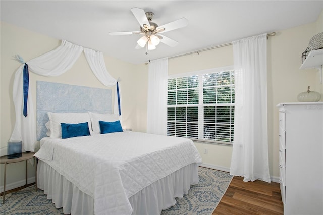 bedroom with ceiling fan and dark wood-type flooring