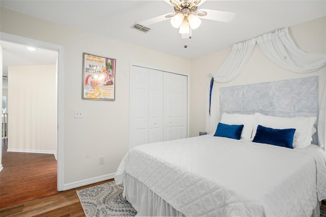 bedroom featuring hardwood / wood-style flooring, ceiling fan, and a closet