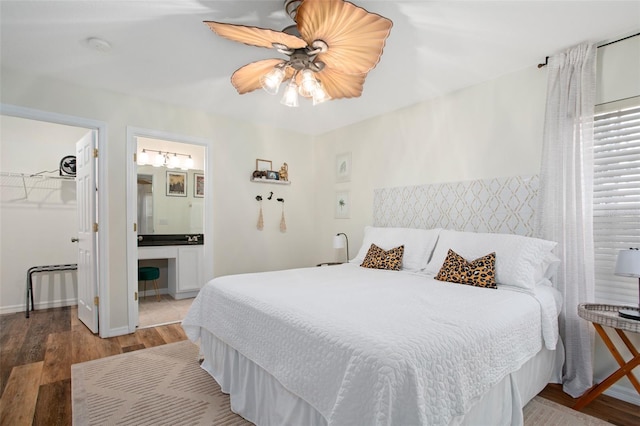 bedroom featuring a walk in closet, ensuite bathroom, ceiling fan, hardwood / wood-style floors, and a closet