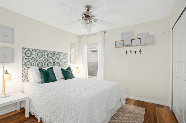 bedroom with dark hardwood / wood-style flooring, a closet, and ceiling fan