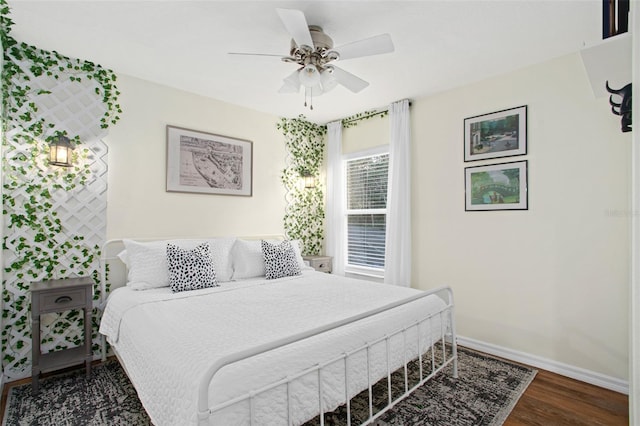 bedroom with ceiling fan and dark wood-type flooring