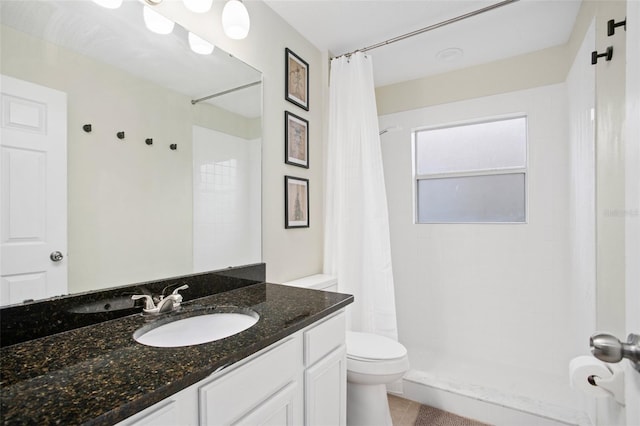 bathroom with a shower with curtain, vanity, and toilet