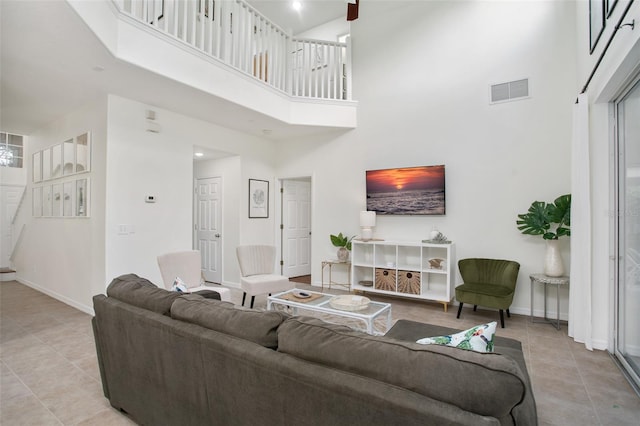 tiled living room with a towering ceiling