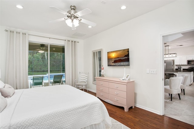 bedroom featuring access to outside, stainless steel refrigerator, ceiling fan, and dark wood-type flooring