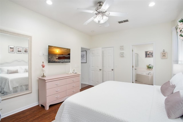 bedroom featuring dark hardwood / wood-style flooring, a closet, ensuite bath, and ceiling fan