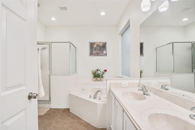 bathroom with tile patterned flooring, vanity, and plus walk in shower