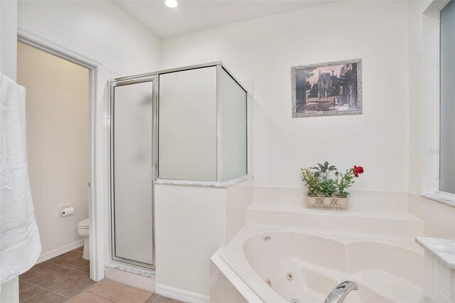 bathroom with tile patterned flooring, shower with separate bathtub, and toilet