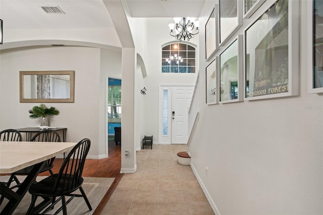 entryway featuring a chandelier and light tile patterned floors