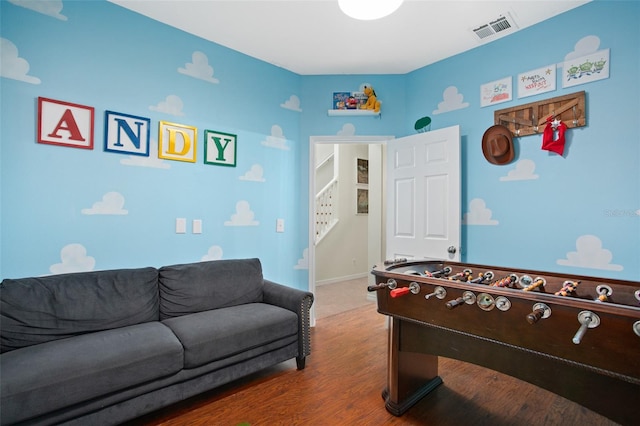 recreation room with wood-type flooring