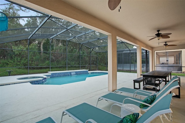 view of pool with a lanai, an in ground hot tub, ceiling fan, and a patio