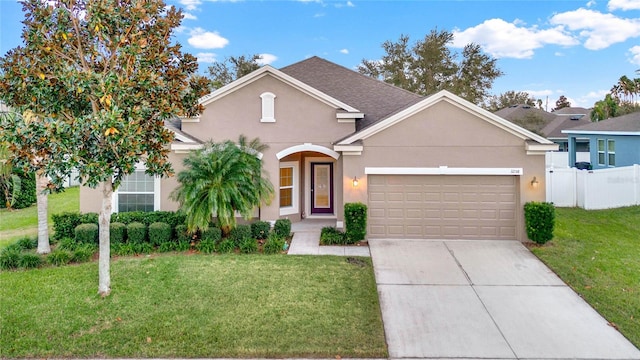 view of front of home with a garage and a front yard