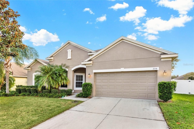 view of front of property featuring a front yard and a garage