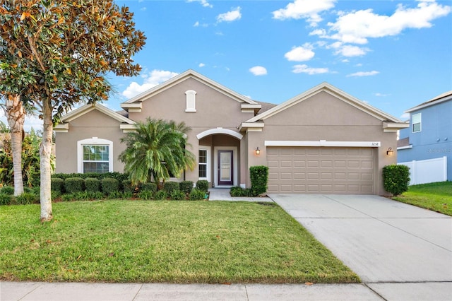 view of front of property with a garage and a front lawn