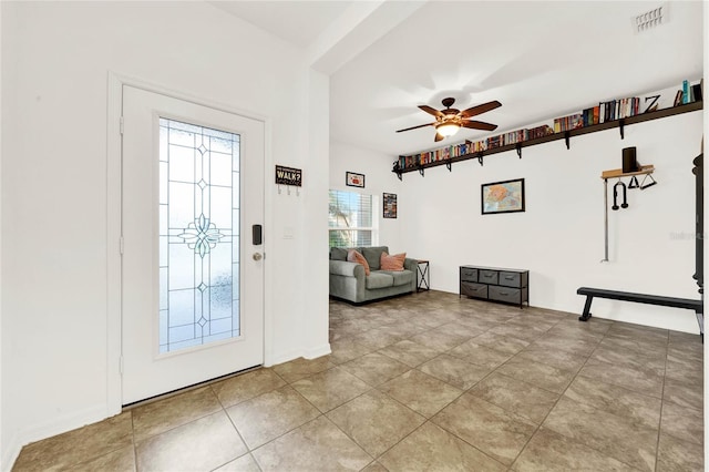 tiled foyer entrance with ceiling fan