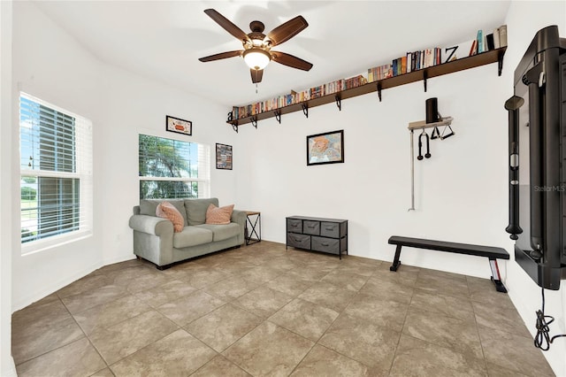 living area featuring ceiling fan and light tile patterned floors