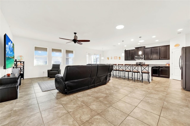 tiled living room featuring ceiling fan