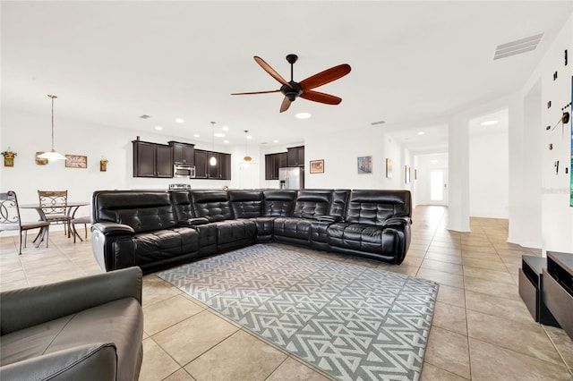 tiled living room with ceiling fan