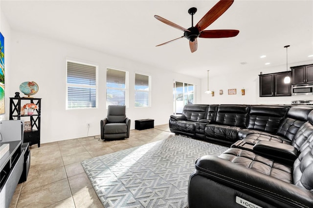 living room featuring ceiling fan and light tile patterned floors