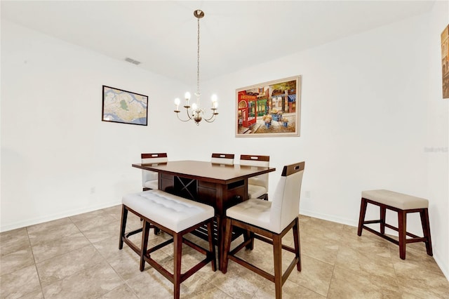 dining area featuring light tile patterned floors and a chandelier