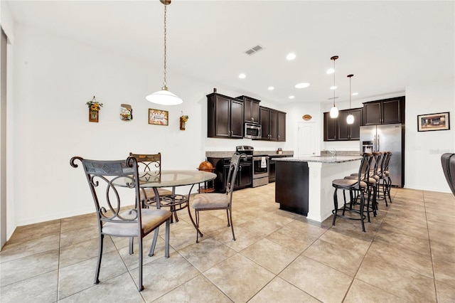 dining space featuring sink and light tile patterned floors