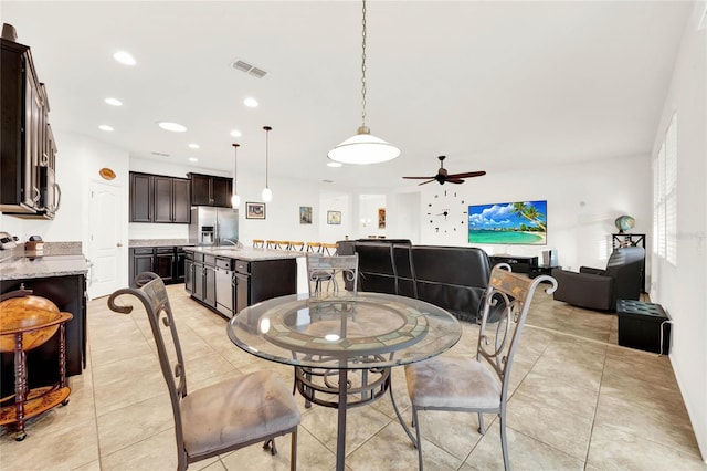 tiled dining room with ceiling fan