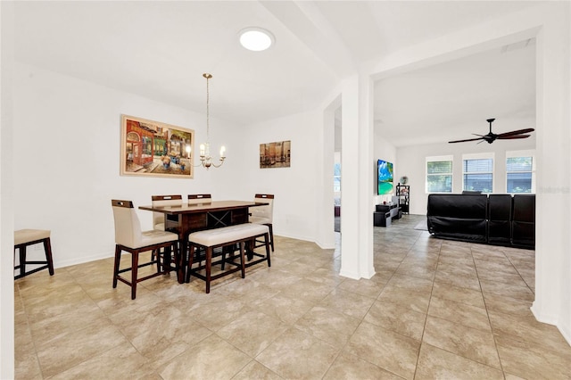 tiled dining room with ceiling fan with notable chandelier