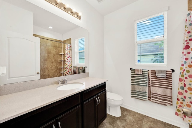 bathroom with vanity, toilet, and walk in shower