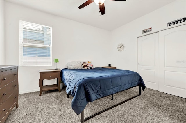 carpeted bedroom featuring a closet and ceiling fan