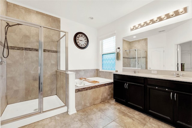 bathroom with tile patterned floors, vanity, and plus walk in shower