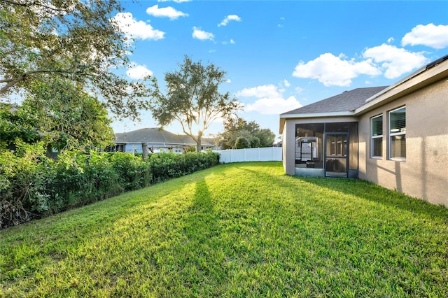 view of yard with a sunroom