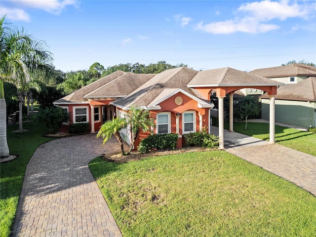 single story home with a front yard and a carport