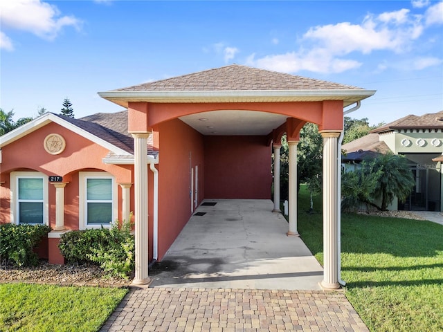 exterior space featuring a front yard and a carport