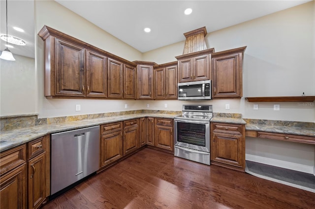 kitchen with light stone countertops, appliances with stainless steel finishes, and dark wood-type flooring