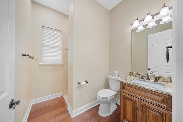 bathroom featuring vanity, hardwood / wood-style flooring, and toilet