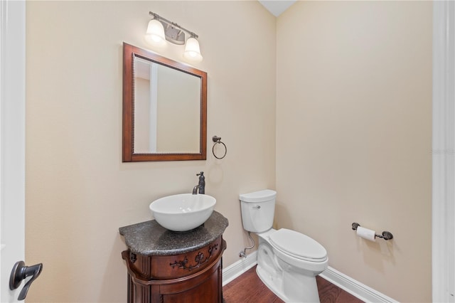 bathroom featuring hardwood / wood-style floors, vanity, and toilet