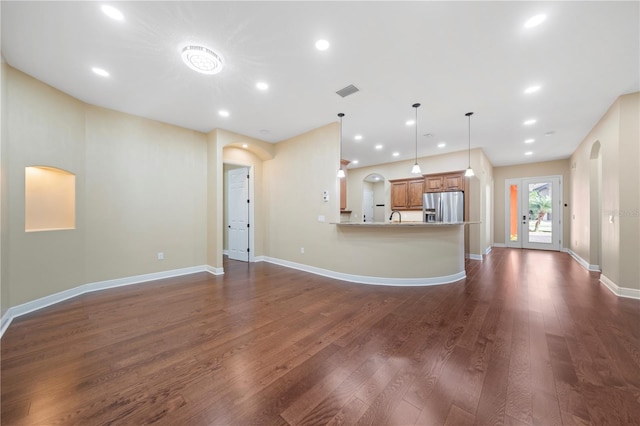 unfurnished living room with french doors, dark wood-type flooring, and sink